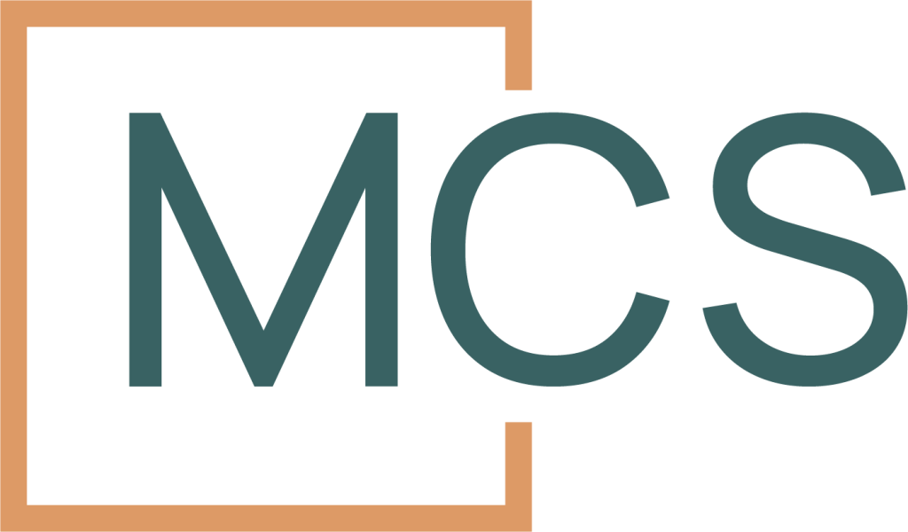 The image shows the letters "MCS" in large, bold, greenish-blue font, partially enclosed by an incomplete orange square frame—suggesting affordable family mediation on a light grey background.